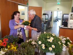 Bewohnende und Mitarbeiterin mit Blumen