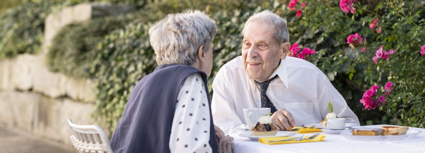 Mann und Frau am Tisch draussen